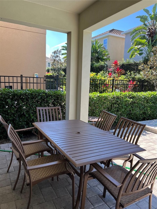 view of patio featuring outdoor dining space and fence