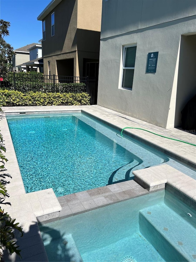 view of swimming pool featuring fence and a fenced in pool