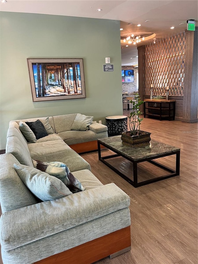 living area featuring a community bar, recessed lighting, and wood finished floors