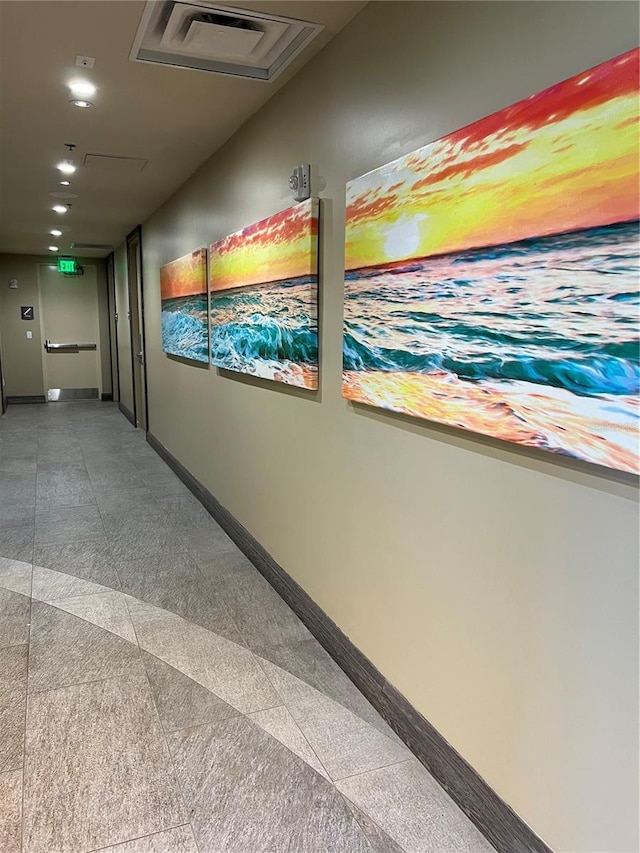 corridor with visible vents, baseboards, and recessed lighting