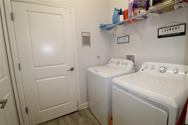 washroom featuring separate washer and dryer and hardwood / wood-style flooring