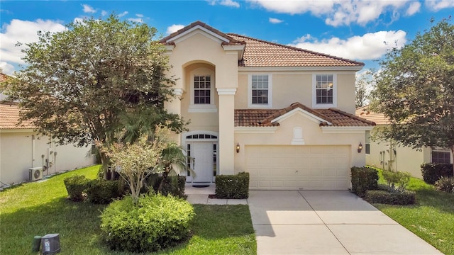 mediterranean / spanish house featuring a garage and a front lawn