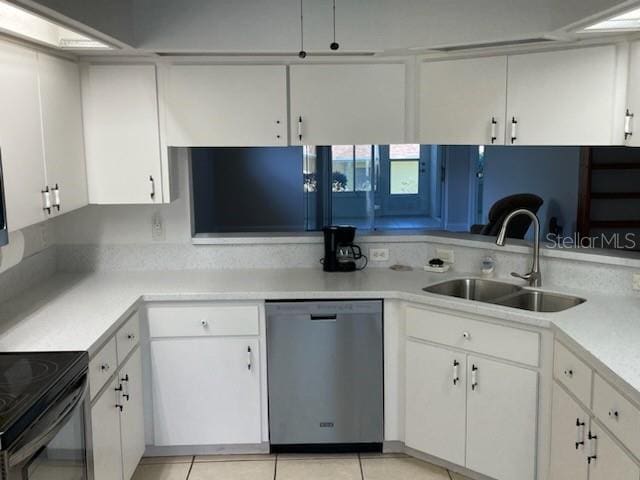 kitchen featuring light tile patterned floors, dishwasher, white cabinets, and sink