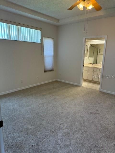 empty room featuring light colored carpet and ceiling fan