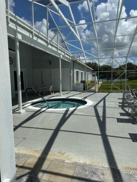 view of swimming pool featuring a lanai and a patio