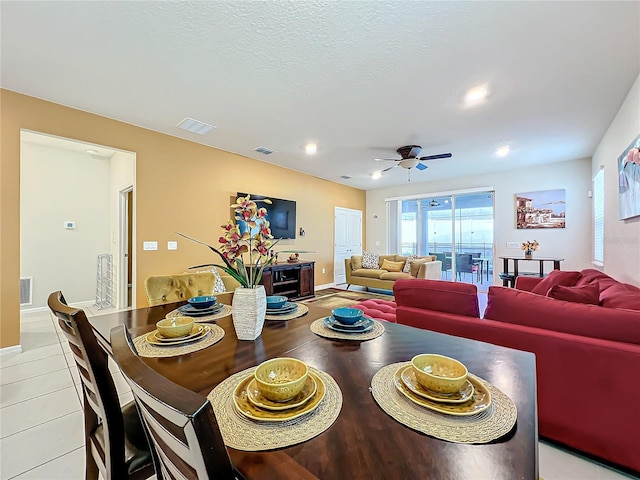 tiled dining area featuring ceiling fan