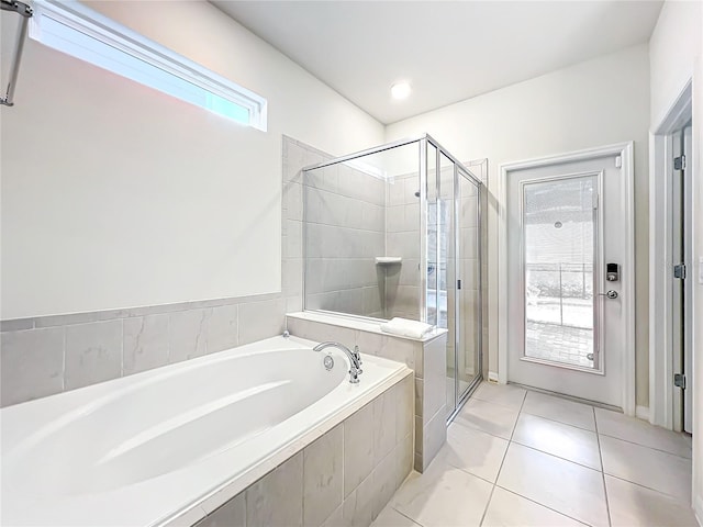 bathroom with independent shower and bath and tile flooring