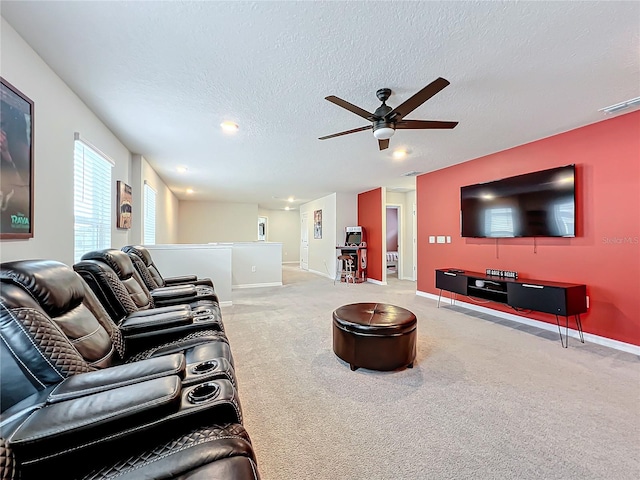 carpeted living room featuring ceiling fan and a textured ceiling