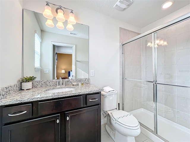 bathroom featuring an enclosed shower, toilet, large vanity, and tile flooring