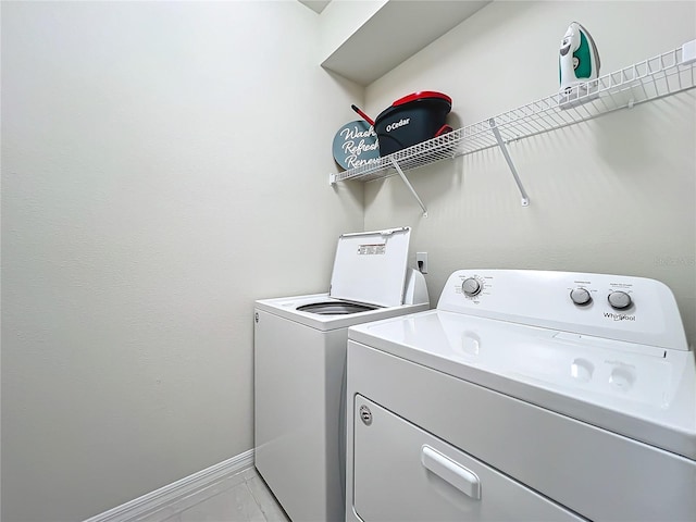 laundry room with light tile flooring and independent washer and dryer