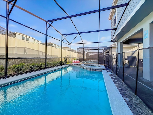 view of pool featuring an in ground hot tub and a lanai