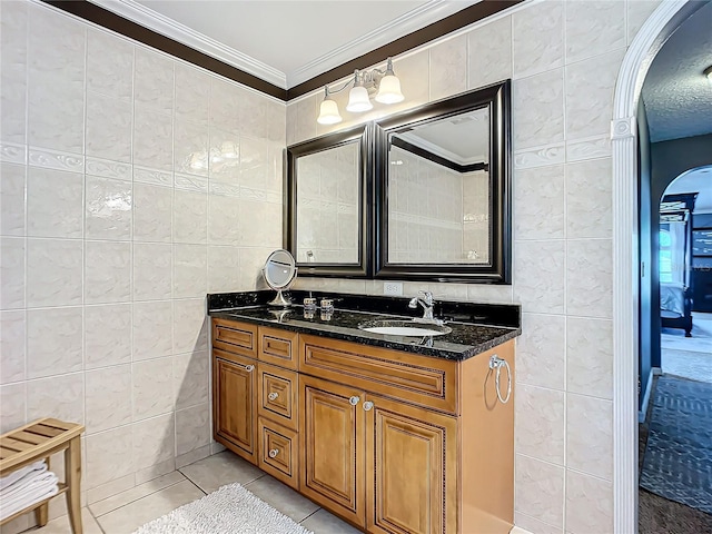 bathroom with tile floors, large vanity, and tile walls