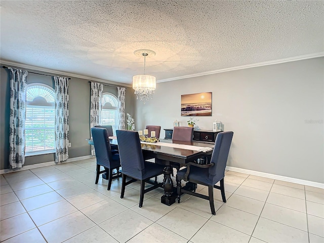 tiled dining area with ornamental molding, a textured ceiling, and an inviting chandelier