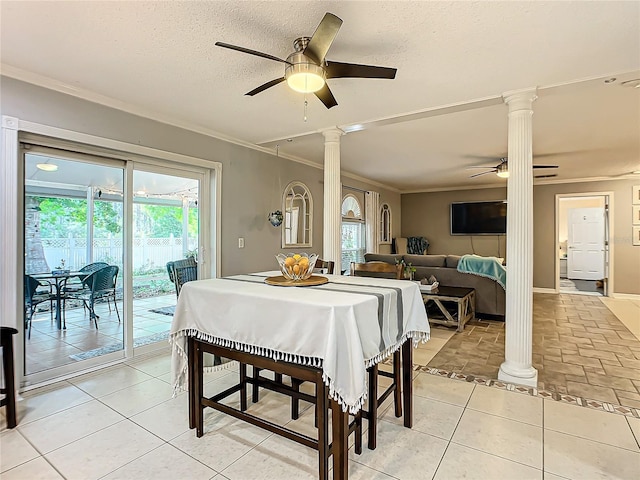 dining area featuring light tile floors, ceiling fan, and decorative columns