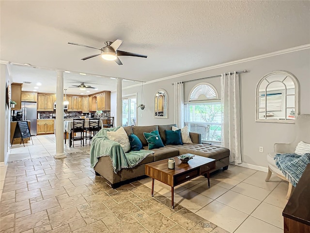 living room with ornamental molding, ceiling fan, light tile floors, and ornate columns