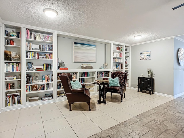 sitting room featuring built in shelves, light tile floors, and a textured ceiling