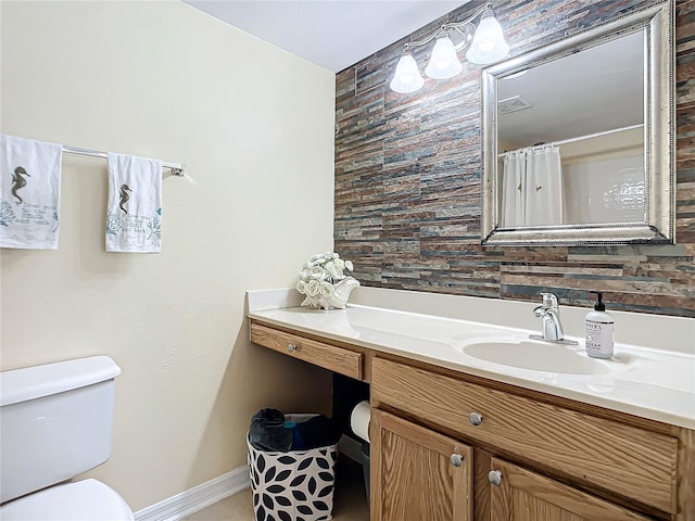 bathroom with tasteful backsplash, large vanity, and toilet