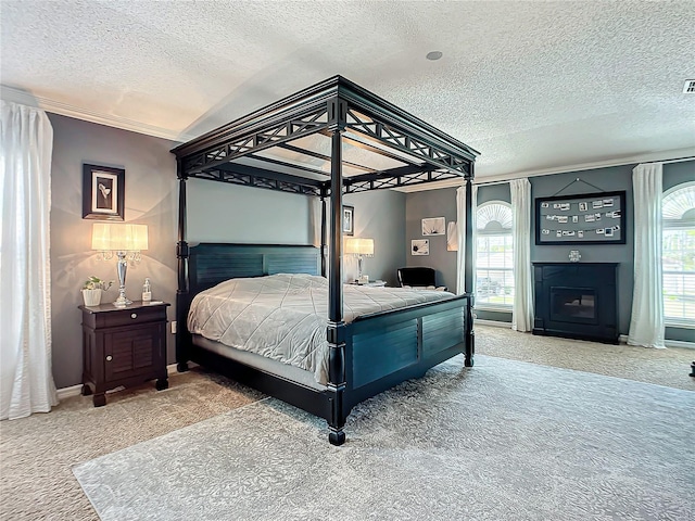 bedroom with a textured ceiling and light colored carpet