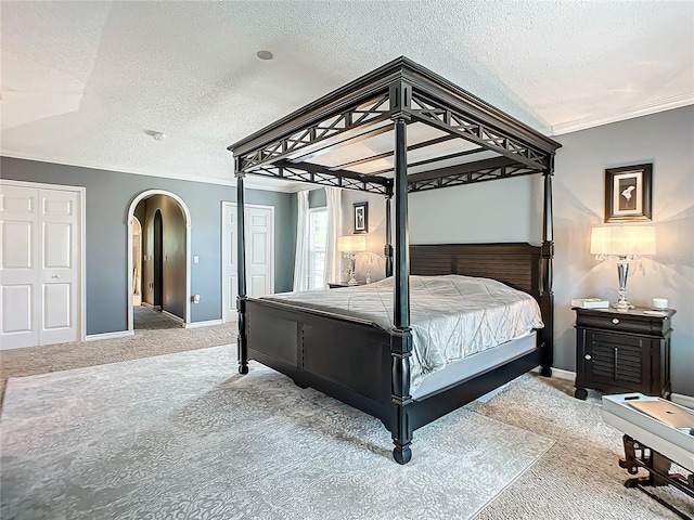 bedroom featuring a textured ceiling and light colored carpet