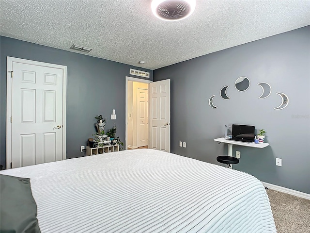 carpeted bedroom featuring a textured ceiling