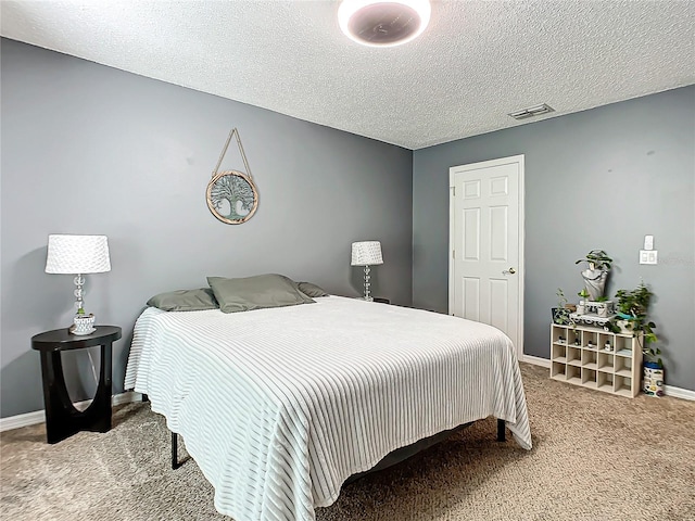 carpeted bedroom featuring a textured ceiling