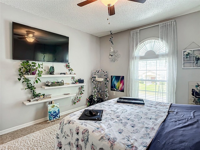 bedroom with a textured ceiling and ceiling fan