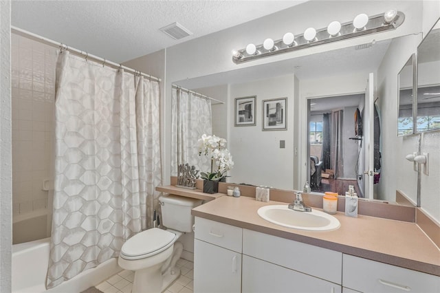 full bathroom with tile patterned floors, vanity, a textured ceiling, shower / bath combo with shower curtain, and toilet