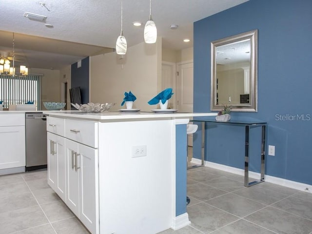 kitchen featuring white cabinetry, stainless steel dishwasher, light tile patterned floors, a center island, and hanging light fixtures