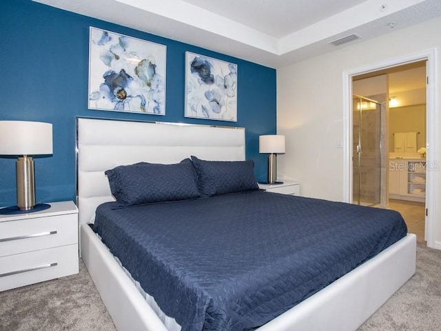 carpeted bedroom featuring ensuite bathroom