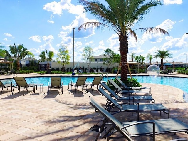 view of pool with a patio area and pool water feature