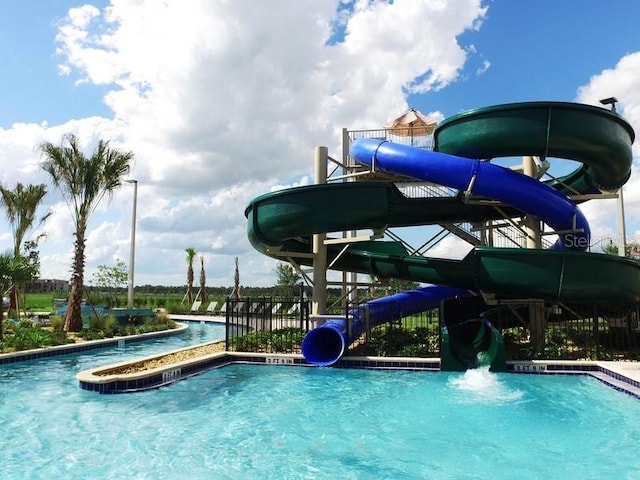 view of swimming pool with a water slide