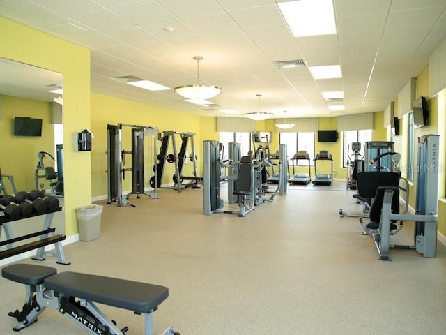 exercise room with a paneled ceiling