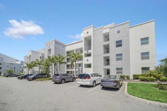 view of property featuring uncovered parking