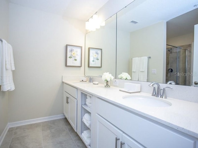 full bath featuring double vanity, a stall shower, visible vents, and a sink