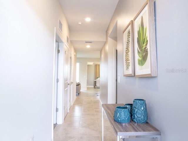 hall with light tile patterned floors