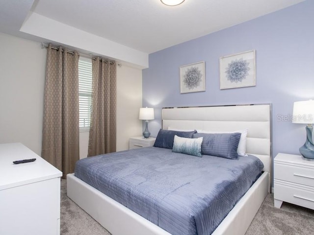 bedroom featuring light carpet