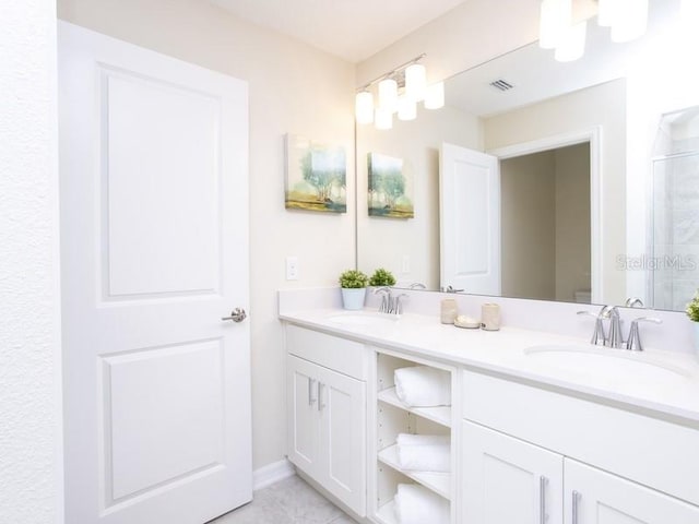 bathroom featuring vanity, an enclosed shower, and tile patterned floors