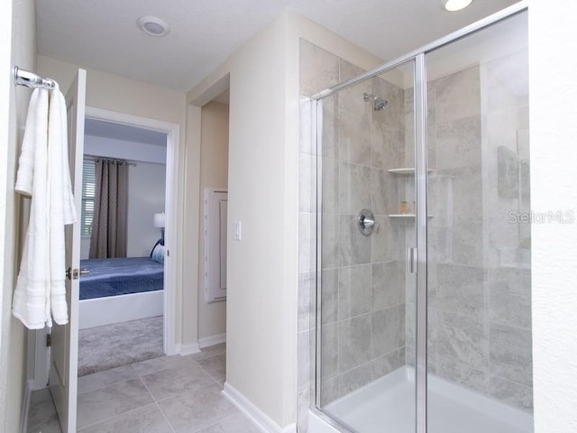 bathroom with tile patterned flooring and a shower with shower door