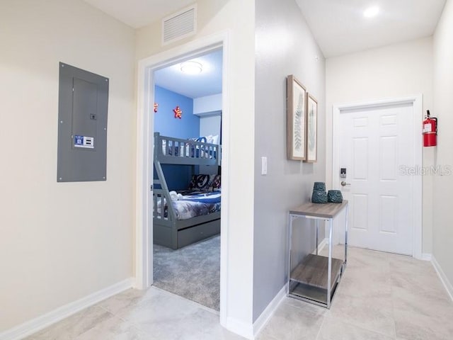 hallway with electric panel and light colored carpet