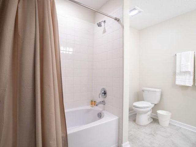 bathroom featuring shower / bath combination with curtain and toilet