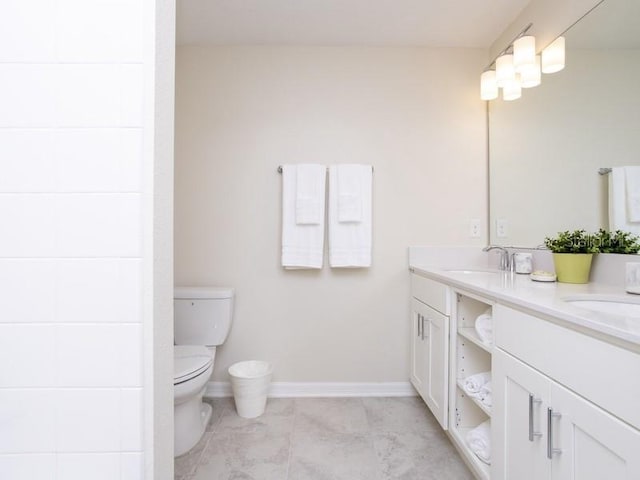 bathroom featuring toilet and vanity