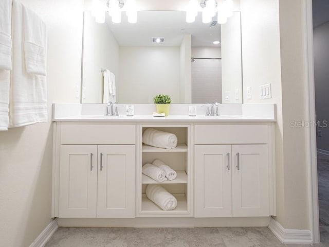 bathroom with vanity, a shower, and tile patterned floors