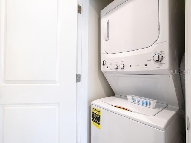 washroom with stacked washer / drying machine