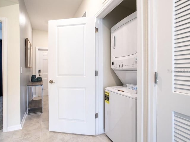 clothes washing area featuring stacked washer / dryer