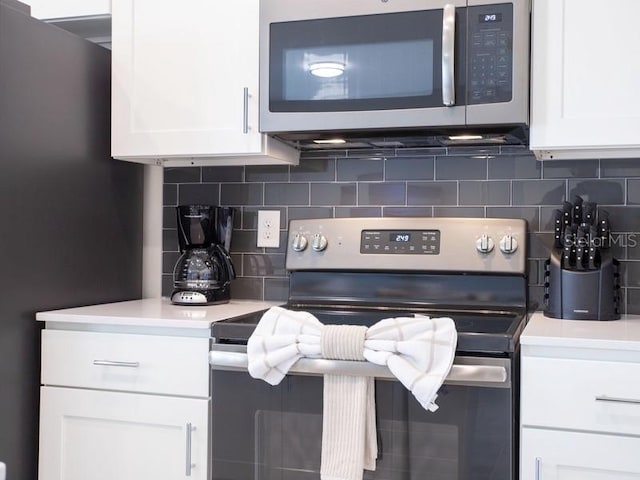 kitchen with appliances with stainless steel finishes and white cabinetry