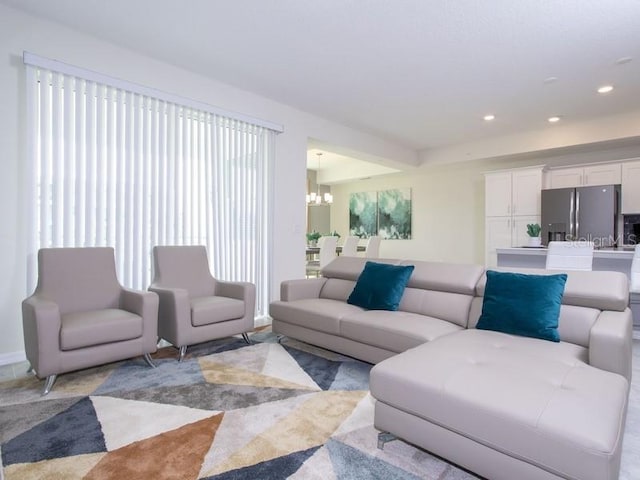 living room featuring a healthy amount of sunlight and a notable chandelier