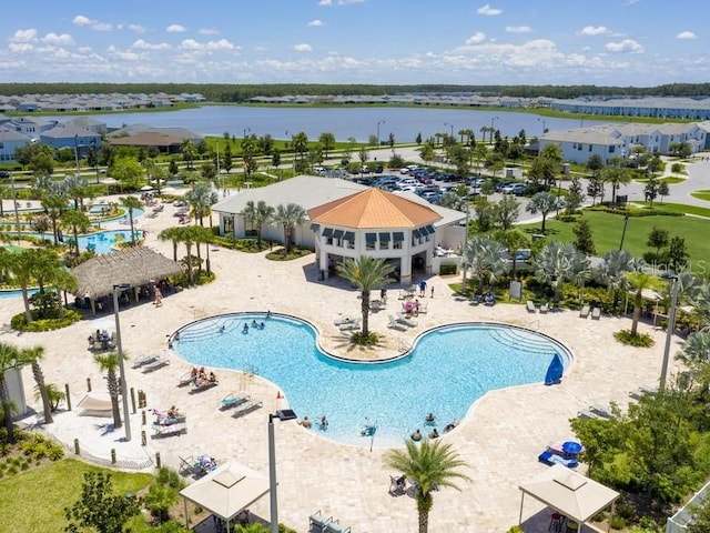 view of swimming pool featuring a water view, a gazebo, and a patio