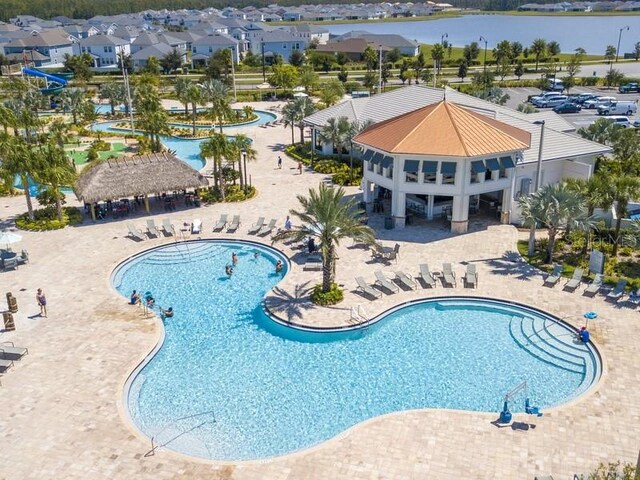 view of pool with a water view, a patio, and a gazebo