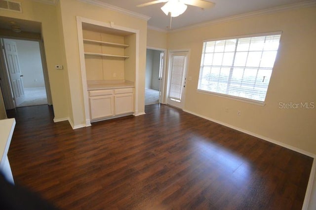 unfurnished bedroom with ornamental molding, dark hardwood / wood-style flooring, a closet, and ceiling fan