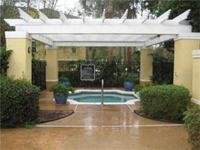 view of pool featuring a pergola, a hot tub, and sink